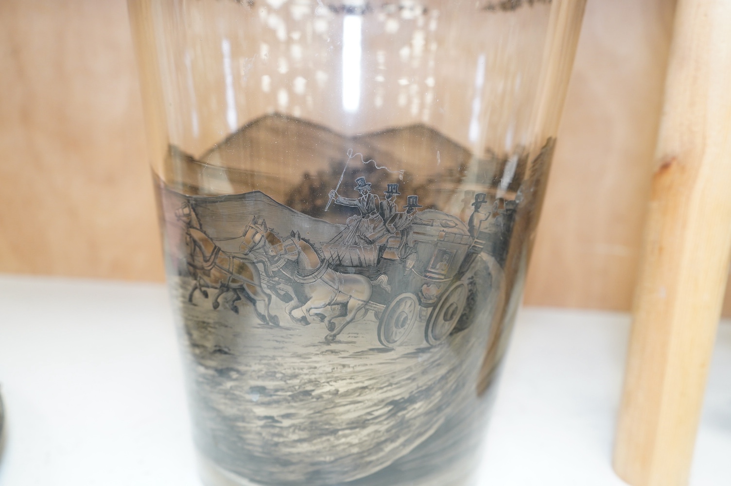 A large German Schwarzlot glass beaker vase, decorated with a painted agricultural scene, 27.5cm high. Condition - fair to good, one chip to the rim and scratches to the base